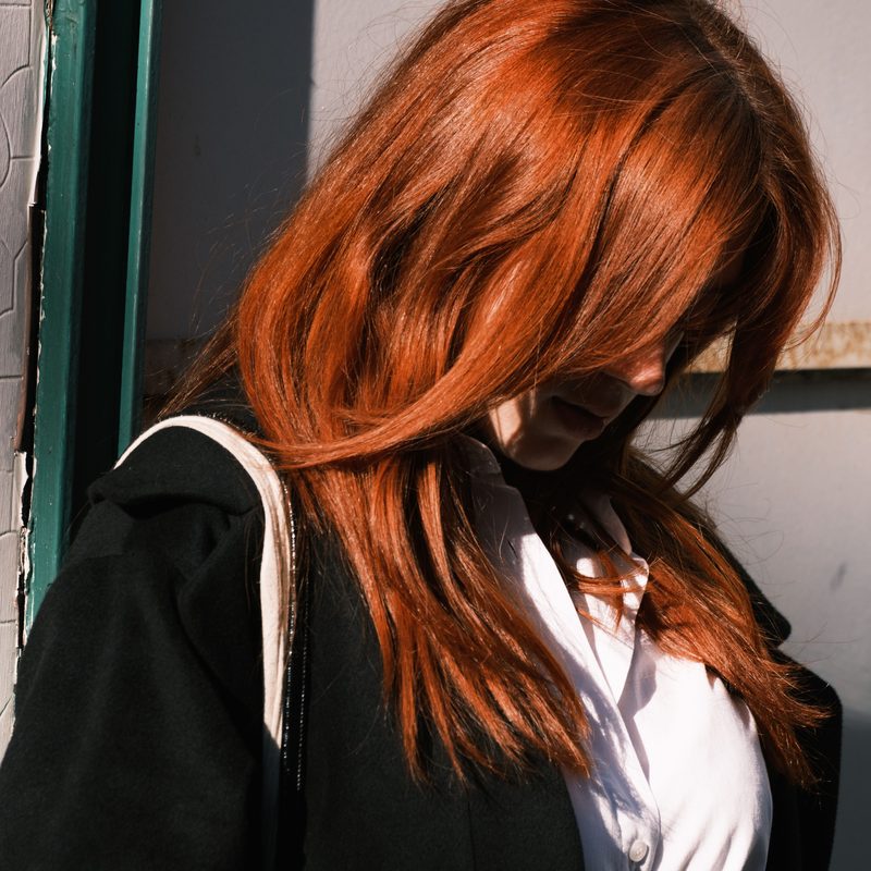 Molten copper colour on long waved hair, finished at the salon